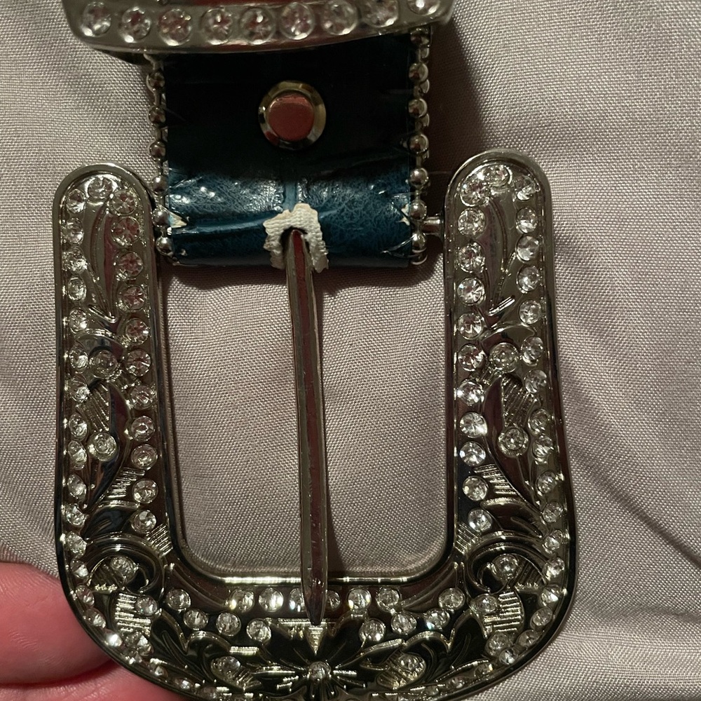 Teal womens belt with bling buckle. Man made materials